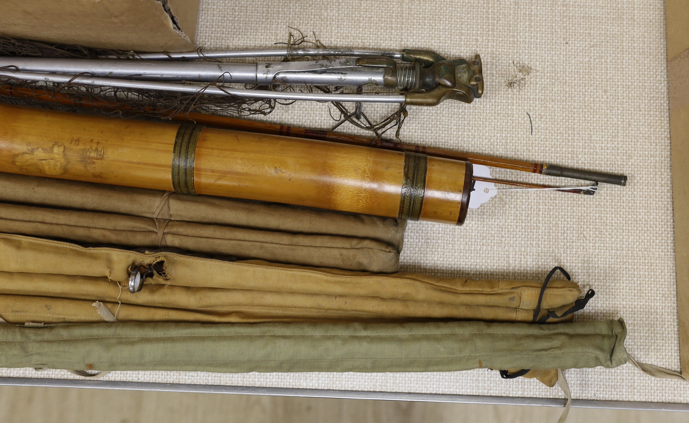 A Hardy's fishing net, together with two canvas cased Hardy’s fishing rods, 'The Murdoch' and 'The Fairy